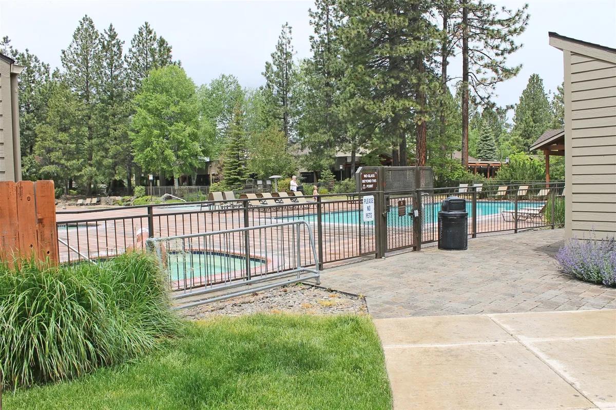 Featuring an outdoor swimming pool surrounded by lounge chairs and greenery, this image highlights the resort's extensive amenities. The relaxed setting invites guests to unwind and enjoy leisurely moments together in the fresh air.